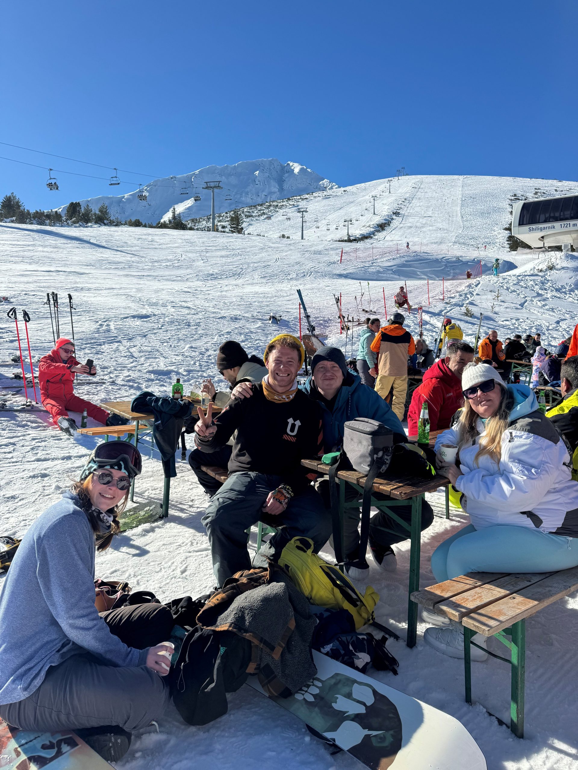 Peopel enjoying a drink outside a mountain restaurant in Bansko