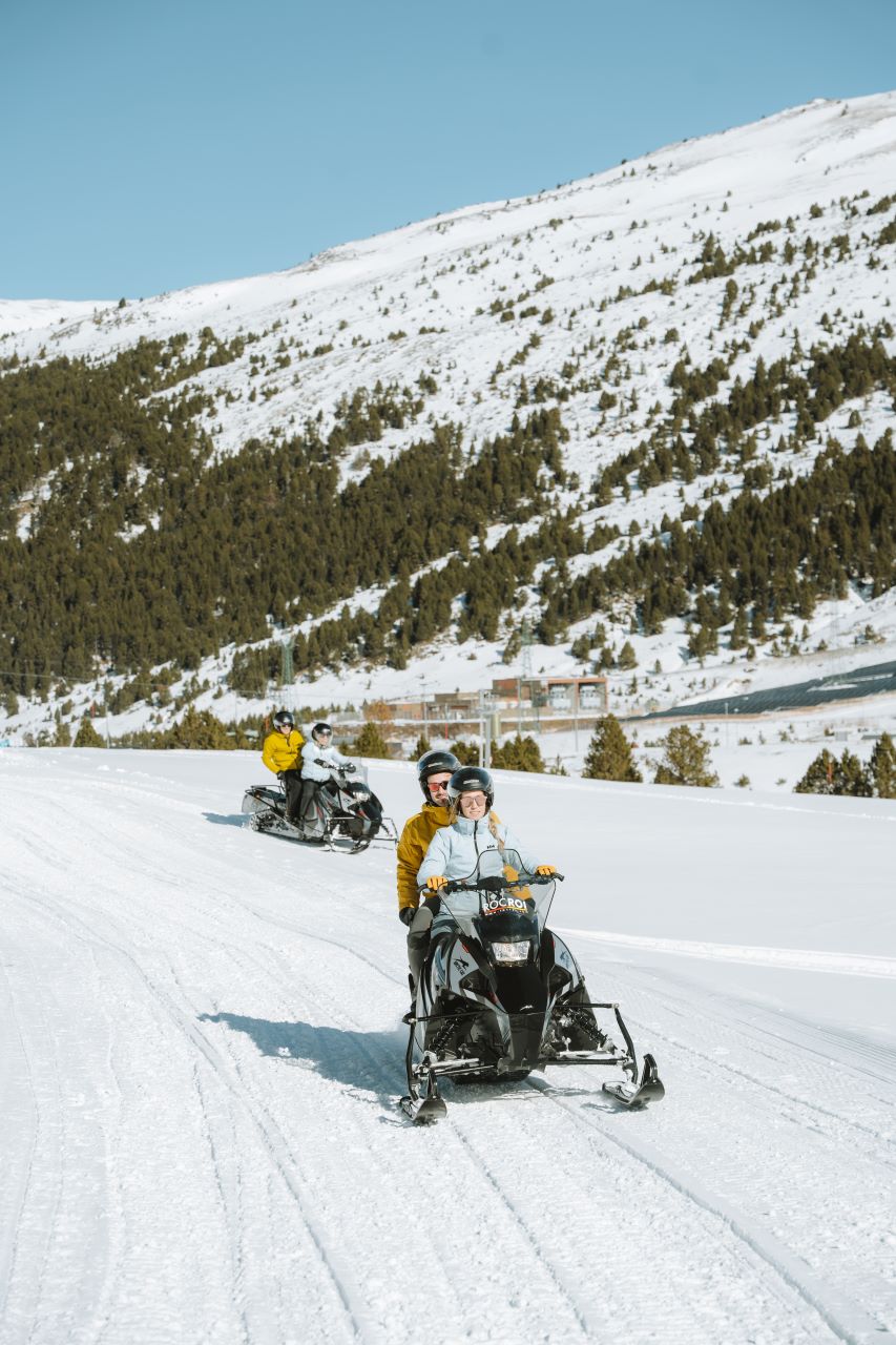People enjoying a skidoo ride on the snow in Grandvalira, Andorra