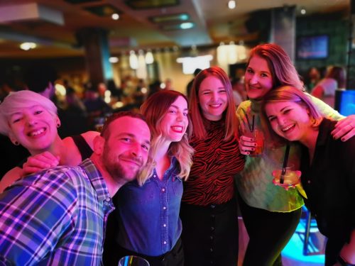 a group of people having a night out with drinks