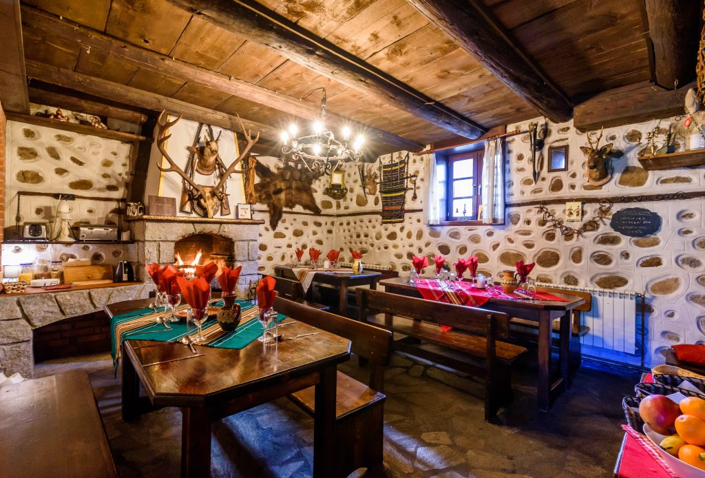 Guests enjoy dinner together in the dining room at Chalet Mila in Bansko.