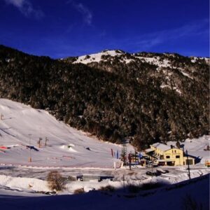 A view of Hotel Chalet Peretol in Granvalira, Andorra from a distance with the ski slope.